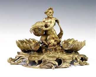 A 19th century French Gilt Bronze desk stand with figure of Poseidon.  Depicted seated upon a sea monster holding a hinged shell flanked by shell holders on a scrolled Rococo style base.  Some wear to patina and loose elements.  Approx. 10 x 6 x 7" high overall.  
