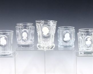 Five 19th century French Sulfide glass portrait tumblers, several likely Baccarat.  Ceramic cameo portraits of notable figures encased in clear molded glass.  Inlcudes portraits of Goethe, Alexander I, St. Margeurite, St. Jean Charles X and others.  Minor surface wear and flakes, saint tumblers both with small chips to foot.  Up to 4 3/4" high.  
