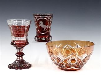 Three pieces of 19th and early 20th century Czech Bohemian Crystal.  Includes a bowl, commemorative goblet and glass with Amber and Ruby cut to clear decoration.  Minor surface wear.  Up to 8 1/4 diameter and 8 1/4" high.  
