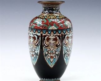 A Japanese Cloisonne vase.  Baluster form with multicolor floral and dragon design.  Unmarked.  Minor surface wear, losses to enamel at inner lip.  7 1/2" high.  
