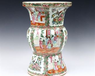 A Chinese Rose Medallion porcelain Ku vase.  Footed Ku form with polychrome vignette panels depicting alternating floral and Court scenes.  Unmarked.  Some wear and losses to decoration.  14 3/4" high.  
