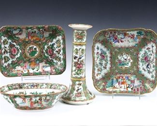 Four pieces of Chinese Rose Medallion porcelain.  Includes a candlestick, a square dish, a smaller rectangular dish and an oval bowl with polychrome vignette panels depicting alternating floral and Court scenes with Gilded detail.  Unmarked.  Some wear to decoration, some small repairs to candlestick, square dish with chips to rim.  Up to 9" long and 10 1/4" high.  
