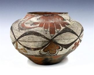An early 20th century Acoma Pueblo art pottery olla.  Bulbous form with polychrome finish.  Some surface wear, small chips to rim.  10" diameter, 7 1/2" high.  

