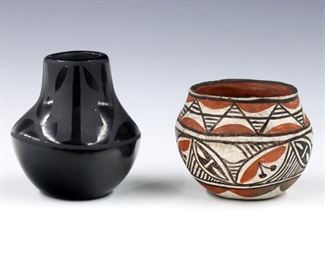Two pieces of 20th century Santa Clara and Acoma Pueblo art pottery.  Includes a Santa Clara Blackware jar by Bertha Singer, and a small Acoma olla.  Blackware jar signed "Bertha Singer, Santa Clara" at underside.  Minor surface wear, some tiny flakes to Acoma olla.  Up to 4 1/2" high.  
