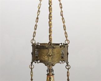 A turn of the century American Arts & Crafts Period attributed to Handel.  Hammered Brass body with pierced detail, five lights suspended by chains.  Old finish with minor wear, re-wired, reproduction shades.  18" diameter x 51" high plus additional chain.  
