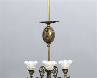 A late 19th century American Victorian Period gasolier.  Brass with six scrolled arms on a central column with pierced detail and ruffled glass shades. 