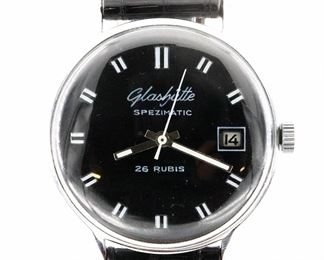 A vintage Glaschutte "Spezimatic" model Gentleman's wristwatch.  26 j, automatic wind with Black dial, Roman numerals and date aperture at 3:00.  36 mm Stainless case with replaced leather band.  Slight wear, restored dial, winds, sets and running when cataloged.  
