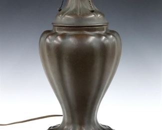 An early 20th century Handel table lamp.  Reverse painted shade #6633 with landscape decoration over a mottled Green ground, on a bulbous Bronze base with circular foot and patinated finish.  Shade with painted "Handel 6633" signature and marked "Handel" at foot.  Shade with significant cracks as-is, minor wear to patina.  Shade is 19" diameter, 22" high overall.  ESTIMATE $400-600
