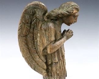 An 18th century German carved wood figure of an angel.  Depicted looking downward with hands clasped in prayer.  Traces of old Gilding visible, some surface wear, insect damage and shrinkage.  9 1/2" high.  
