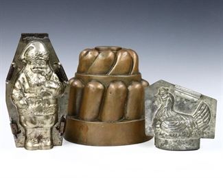 Three late 19th to early 20th century copper and tin food molds.  Includes a copper over tin jello mold and two tin chocolate molds depicting a rooster and Santa Claus.  Santa Claus marked "Made in Germany".  Wear and some denting.  Up to 7" high.  ESTIMATE 
