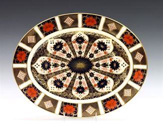 A 20th century Royal Crown Derby "Old Imari" pattern fine bone china oval serving platter.  Printed marks in Red with "1128" and "LII".  Good condition, very slight surface wear, printed mark scratched through.  13 1/2" long.  
