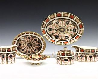 Six 20th century Royal Crown Derby "Old Imari" pattern fine bone china serving pieces.  Includes a 10" long oval bowl, an 8" long oval dish, a 6 1/2" long Duchess sweet dish, a 3 1/2" high gravy boat, a 4" high creamer and 3 1/2" high covered sugar.  Printed marks in Red with "1128" and "LII".  Very slight surface wear, oval bowl with hairline to side, oval dish with some crazing, printed marks scratched through.  
