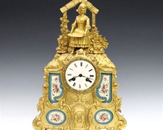 An early 19th century French mantel clock by Henry Marc, Paris.  8 day time and strike movement with silk thread suspension, porcelain dial and Roman numerals signed "2 Hry Marc, a' Paris".  Gilded Bronze case with hand painted porcelain plaques depicts a farm girl standing beneath an arbor.  Minor wear, running when cataloged.  16" high. 