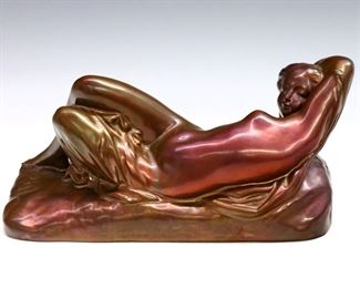 A 20th century Zsolnay art pottery figure.  Depicts a repose nude woman with iridescent Purple/Brown glaze.  Impressed "Zsolnay PECS" mark.  Minor surface wear and crazing.  9 1/2" long.  
