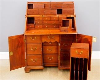 A late 18th century George III Period Campaign desk.  Mahogany construction with a folding upper section that opens to reveal four tiers of compartments and drawers above a pull out writing surface, knee hole base with a recessed central door flanked by paneled end doors, all with interior drawers and compartments.  Several secret drawers throughout.  Original Brass hardware with traces of the original gilding.  Older refinishing with minor wear, some warpage and shrinkage and minor losses.  35 1/2 x 23 1/2 x 42 1/2" high closed, 53 1/2" high when open.  