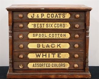A turn of the century J & P Coats general store spool cabinet.  Cherry construction with a molded top and six labeled drawers with Brass knobs.