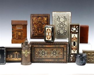 Twelve 19th to mid 20th century small wooden boxes.  Includes a Turkish micro mosaic box, an Egyptian inlaid box, a German stone inlaid box and coin purse, two Italian marquetry boxes, a German carved wooden inkwell in the form of a turret, a Japanese puzzle bank, and others. 