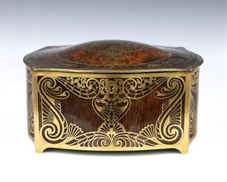 A turn of the century Erhard & Sohne Jugendstil inlaid box, c. 1905.  Fine Rosewood construction with domed Burl top and Brass inlay depicting scrolling florals in the Art Nouveau manner, within a Brass frame with short bracket feet.  Hinged top opens to reveal a single compartment with velvet lining.  
