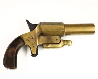 A vintage flare pistol.  Brass barrel and frame with Walnut grips, unmarked.  Some surface wear and pitting.  9 1/2" long.  