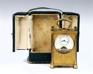A turn of the century French miniature carriage clock.  8-day time only lever movement with exposed balance, porcelain dial with Roman numerals and Blued hands.  Gilded Bronze case with portrait medallion design, fold down handle and convex glass, in the original leather travel case.  Wear to Gilding and case, running when cataloged.  