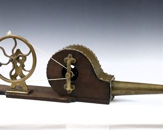 A late 19th century British Victorian Period mechanical peat bellows.  Mahogany and Brass construction with hand-operated wheel and nail head detail.  
