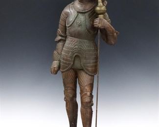 A turn of the century Terracotta figure of Sir Brian de Bois-Guilbert, a Templar knight from "Ivanhoe" by Sir Walter Scott.  Depicted standing in full armor and spear with polychrome painted finish.  Titled "Bois Guilbert" at base.  Original painted finish with wear, chip to knee and foot, some surface wear, spear top an addition.  41" high.  ESTIMATE $300-400