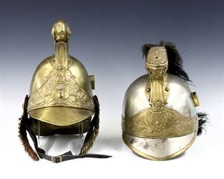 Two 19th and early 20th century French helmets.  Includes a Steel and Brass dragoon helmet with Medusa mask comb, ostrich feather plume and decorative shield by Siraudin of Paris, and a Brass fire brigade helmet with embossed comb, leather/chain chin strap and decorative shield.  Dragoon helmet impressed "Siraudin" with model numbers at back. 