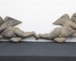 A pair of turn of the century Cast Iron architectural cherub figures.  Some surface wear and rusting.  Each 26" high. 