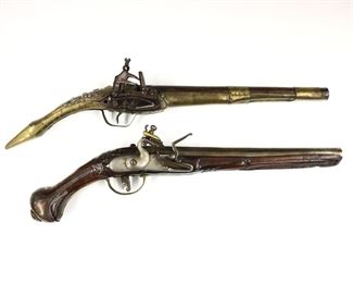 Two antique Pistols.  Includes a .62 Caliber Middle Eastern Flintlock Pistol with 11" barrel and Brass mounted stock with repousse decoration and Steel trigger guard; and a .64 Caliber French Dueling Pistol with 10" barrel, carved Walnut stock with inlaid Steel wire and engraved Steel fittings.  Some wear and pitting overall, Middle Eastern pistol with soldered repairs to Brass, dueling pistol with repaired trigger guard.  19" and 17 1/2" long overall.