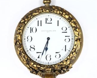 A turn of the century Edward F. Caldwell & Co. Gilded Bronze clock.  8-day stem-wind Swiss movement with a porcelain dial, Arabic numerals and blued hands.  Gilded Bronze case with Neoclassical oak leaf design.  Some wear to patina, minor dents to back rim, not running when catalogued.  8" high.
