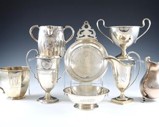 Eight pieces of 19th and 20th century Sterling Silver tableware by various makers.  Includes a porringer, handled cups, creamers, a small trophy and a pedestal bowl.  Impressed marks.  33.46 troy ozs total.  