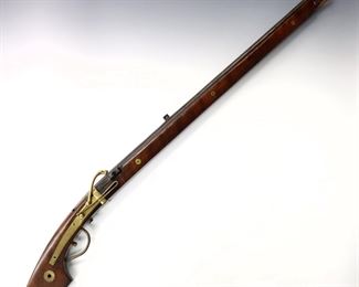 A 17th century Japanese Edo Period Matchlock Long Gun.  Approx..69 Caliber, 30 3/4" barrel with 1 1/4" cannon muzzle and engraved Dragon in Clouds decoration, Walnut stock with Brass fittings.  Stock refinished and Brass polished, pitting to barrel.  42 1/2" long overall.  ESTIMATE $800-1,200