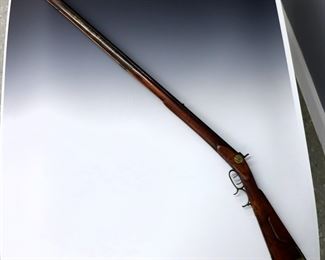 A 19th century Kentucky Percussion Rifle, c. 1845.  .44 Caliber with 39 1/4" octagonal barrel, Curly Maple stock, Brass trigger guard, butt plate and inlaid patch box.  Repaired forestock, older refinishing, some wear to patina.  55 1/2" long overall.  ESTIMATE $300-400