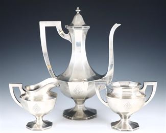 An early 20th century three piece Sterling Silver coffee set retailed by Hess & Culbertson.  Includes a coffee pot, creamer and sugar with octagonal design.  Impressed retailer's mark and "Sterling".  21.50 troy ozs total.  