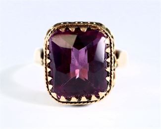 A vintage 14k Yellow Gold ring with a faceted Amethyst stone in a Victorian style setting.  Marked "14k".  6.1 grams total.