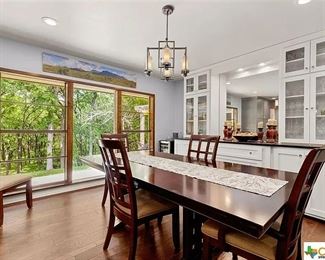 Beautiful dining room table with six chairs extra leafs and custom fitted table pads.