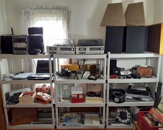 Aiwa digital audio system, CanoScan, HP Deskjet D1520 printer, Sears electric adding machine, Realistic stereo system w/turn table, Kodaslide projector, Vivid Tridar projector, earbuds, View Master, Sears turn table, JVC digital video camera, Gemini tape re-winder, Canon Power Shot camera, Jensen CD player, JVC DVD player, digital picture frame