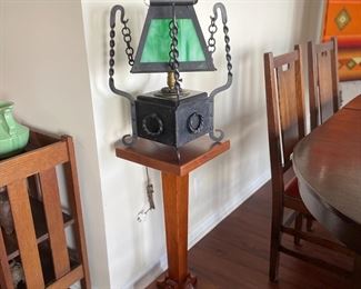 Arts and Crafts table lamp, original twisted iron base and chain supporting a green slag glass shade.  15" wide by 15" wide, 19" tall.  