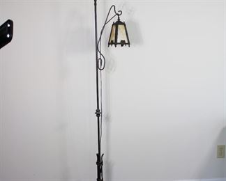 Antique wrought iron Arts and Crafts style floor or bridge lamp with caramel slag glass hanging shade.  61 1/2" tall overall, 47" from floor to bottom of shade