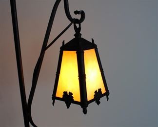 Another view of Antique wrought iron Arts and Crafts style floor or bridge lamp with caramel slag glass hanging shade.  61 1/2" tall overall, 47" from floor to bottom of shade