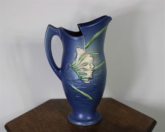 Roseville Pottery Freesia pitcher in blue, #20-10".  Tiny glaze nick on point on handle