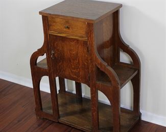 29.  Oak smoking stand with drawer and bookshelves.  30” tall, 25” across,  11 1/2” deep