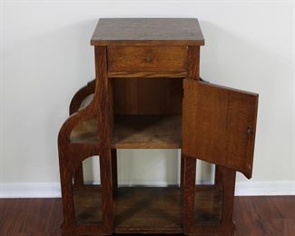 29.  Oak smoking stand with drawer and bookshelves.  30” tall, 25” across,  11 1/2” deep