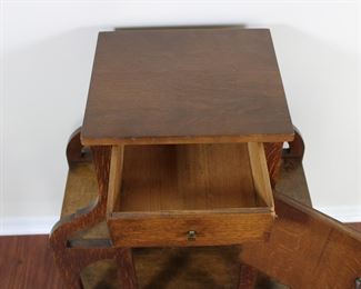 29.  Oak smoking stand with drawer and bookshelves.  30” tall, 25” across,  11 1/2” deep