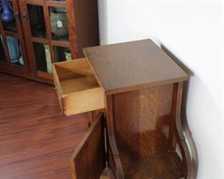 29.  Oak smoking stand with drawer and bookshelves.  30” tall, 25” across,  11 1/2” deep