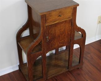 29.  Oak smoking stand with drawer and bookshelves.  30” tall, 25” across,  11 1/2” deep