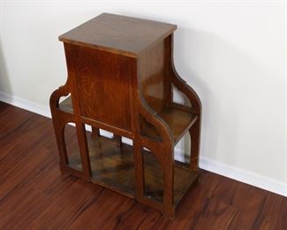 29.  Oak smoking stand with drawer and bookshelves.  30” tall, 25” across,  11 1/2” deep