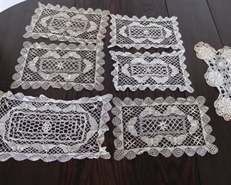 Six old lace doilies with butterflies