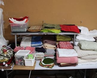 Household linens, napkins, placemats, lovely cotton kitchen towels, many nice cotton bath towels, hand towels, and wash cloths.  Cotton sheets, twin and queen, mattress pads