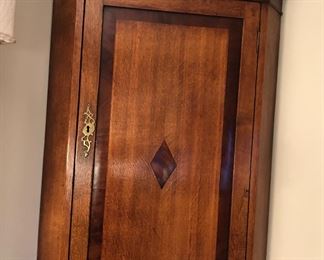Georgian oak corner cabinet with mahogany banding, circa 1800  (wall mounted - 41” tall, 16” deep from back corner to front)